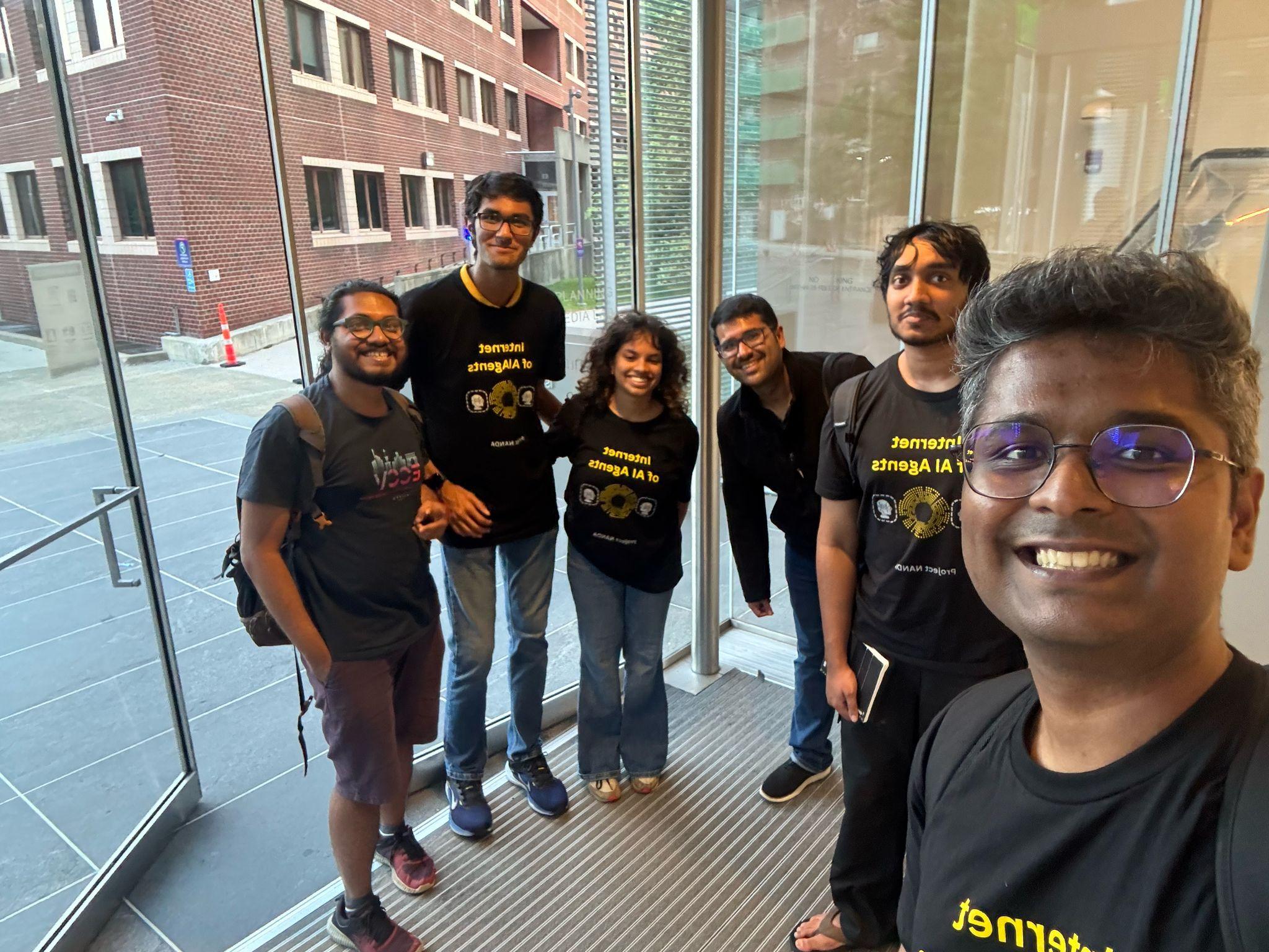 Project NANDA team members taking a group selfie in a campus building